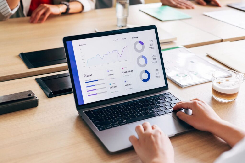 Professional Businessperson Analyzing Data Analytics Report on Laptop in Conference Room